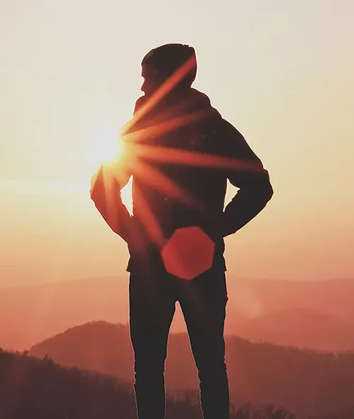 Silhouette of a person watching the sunrise